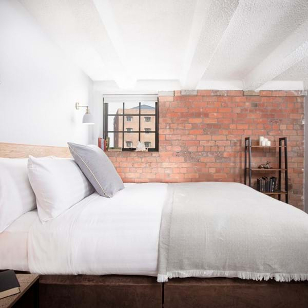 A dockside bedroom at Tobacco Warehouse Image